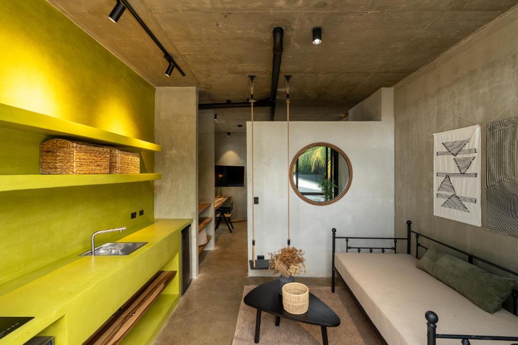 a living room with a couch and a sink at The Sunset Deck in Jacó