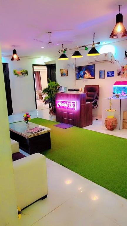 a living room with a couch and a green carpet at Hotel Royal Stay in Gurgaon