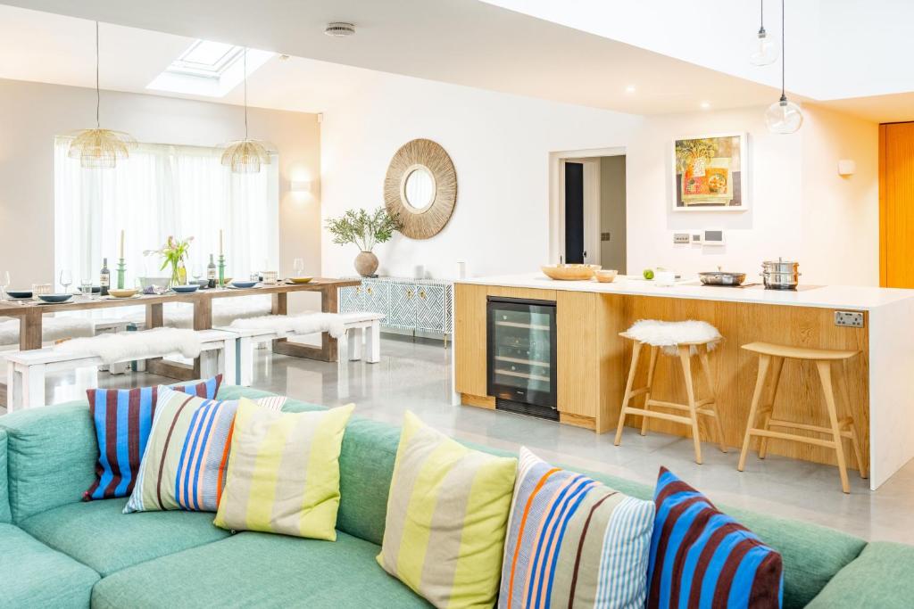 a living room with a couch and a kitchen at Seahenge in Brancaster