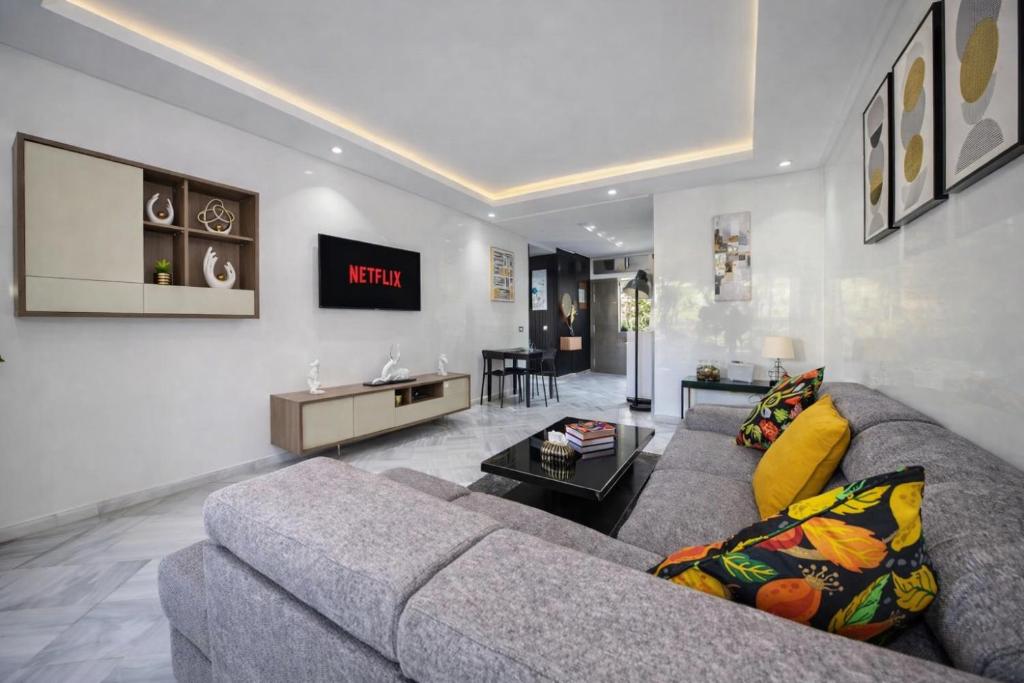 a living room with a couch and a tv at La Siesta Beach Resort in Mohammedia