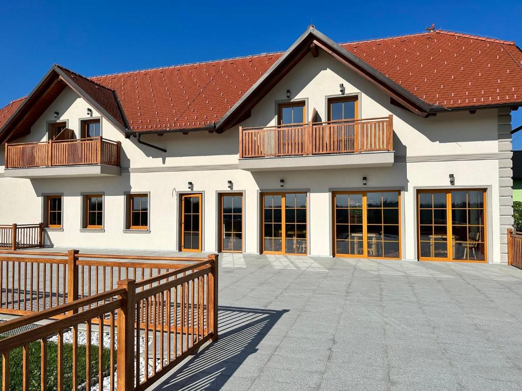 a large white house with a wooden fence at Anivina - B&B in Ivanjkovci