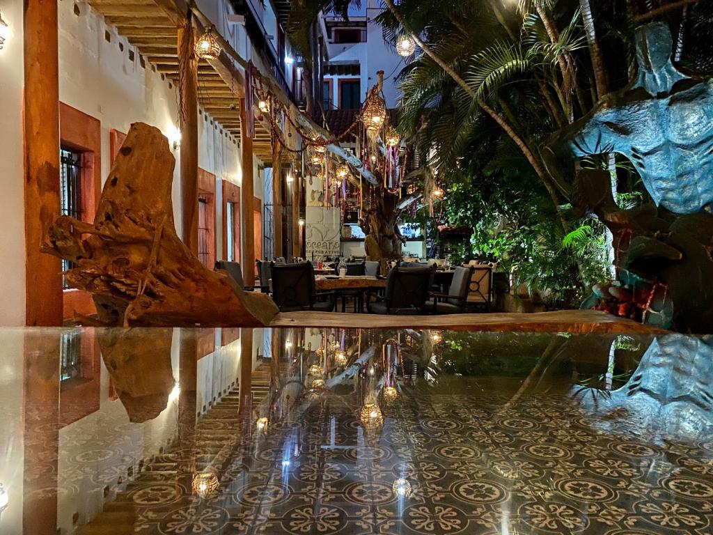 a restaurant with a reflection in a pool of water at Hotel Raices de Mar in Mazatlán