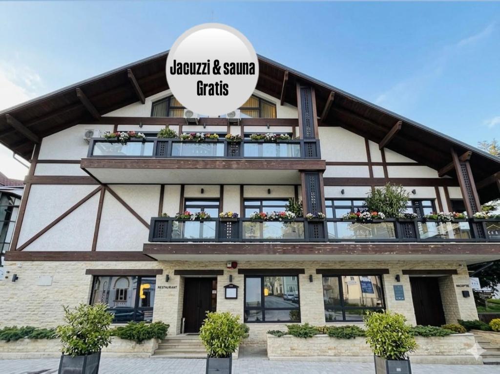 a building with a sign that reads emerald and sunny truths at KABAN BOUTIQUE HOTEL - 5Star Central Villa in Vatra Dornei in Vatra Dornei