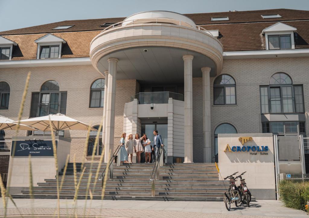a group of people standing in front of a building at Acropolis - Luxury Appartments I Hotelservice and parking in Middelkerke