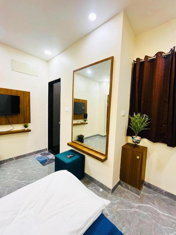 a bedroom with a large mirror and a bed at Hotel G17 and Restaurant in Dhāmnod