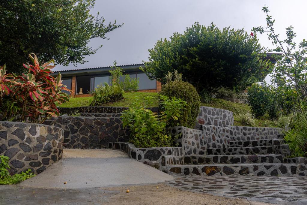 a set of stone stairs in front of a house at Hotel Alto Monte Hacienda & Spa - Only Adults in Chiguirí Arriba
