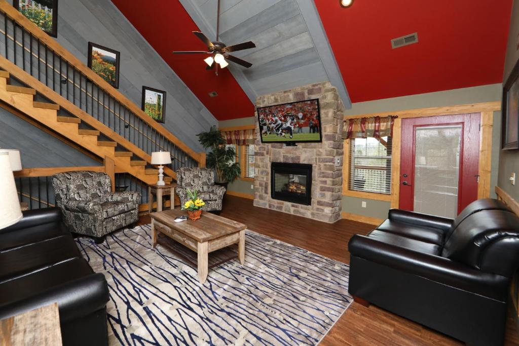 a living room with a couch and a fireplace at Firefly Nights – 5-Bed Mountain Chalet with Private Theater and Elevator in Gatlinburg