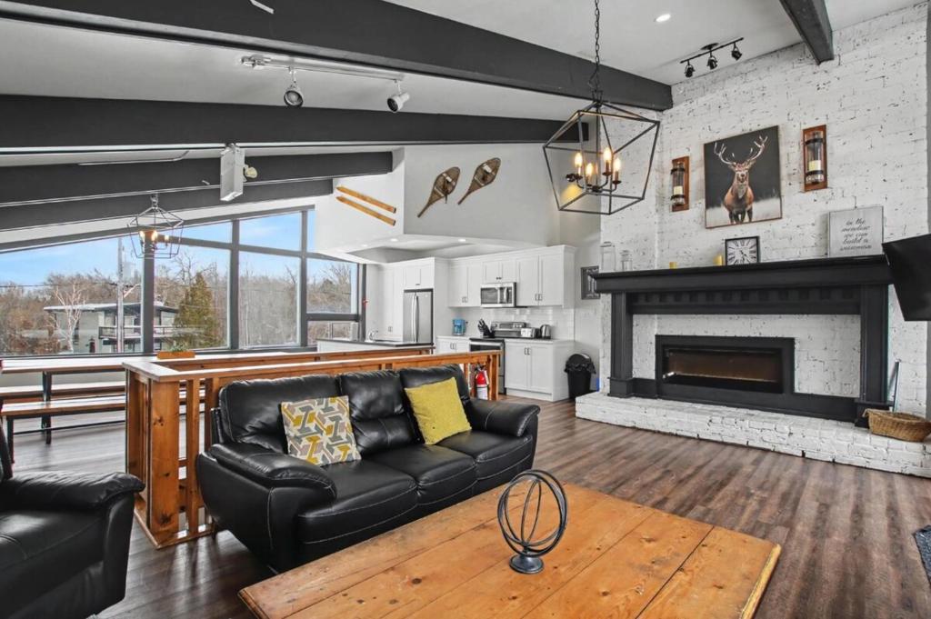 a living room with a couch and a fireplace at Mountain Trail-Smart TV-Self Check-In-Full Kitchen-Balcony-BBQ in Blue Mountains