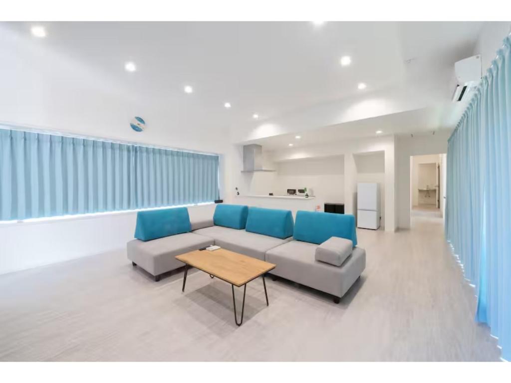 a living room with a couch and a table at Turtle Two Three - Vacation STAY 87759v in Miyako-jima
