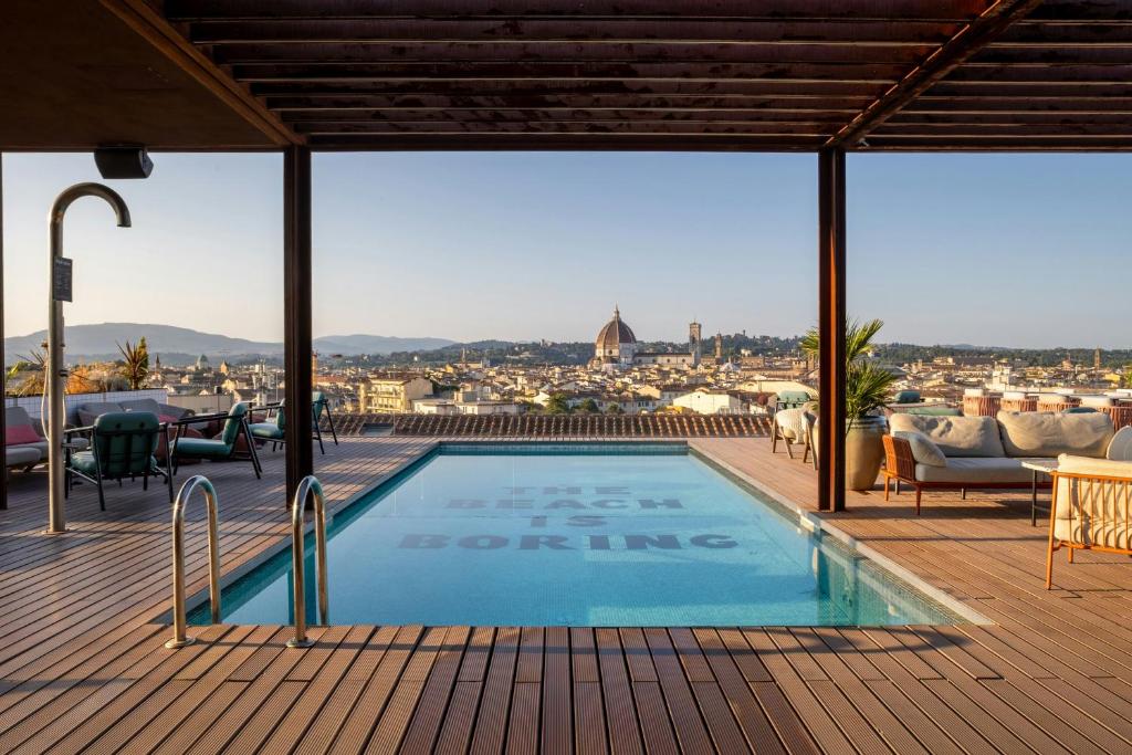 a swimming pool on a deck with a view of the city at The Social Hub Florence Lavagnini in Florence