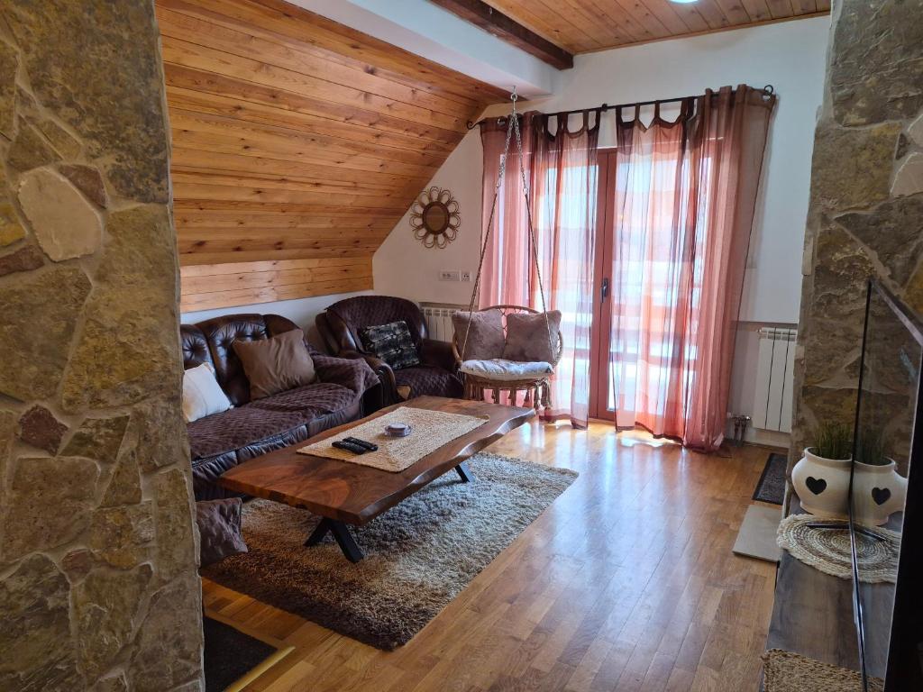 a living room with a couch and a table at Family Apartments in Žabljak