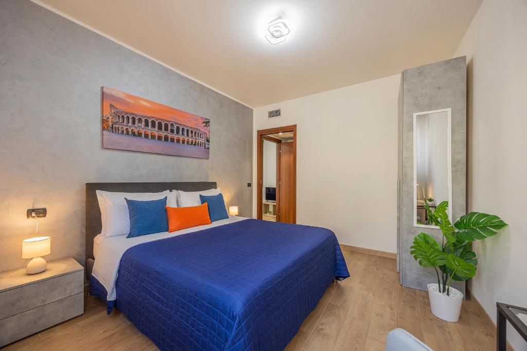 a bedroom with a large blue bed in a room at PRESTIGE Apartments - Blue Serenity in Verona