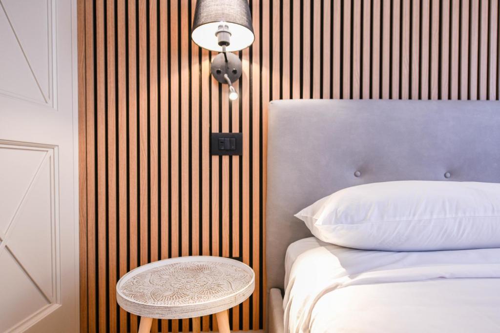 a bedroom with a bed and a table next to it at NEW Appartamenti Anna in Sirmione