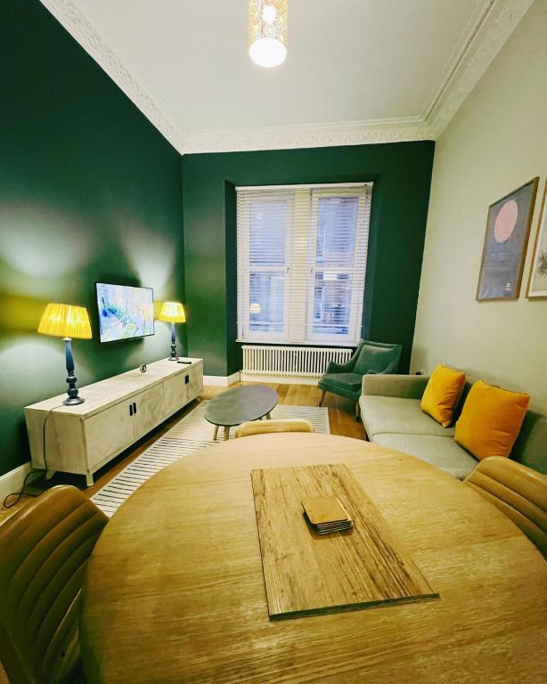a living room with a table and a couch at Central Leith Suite in Edinburgh