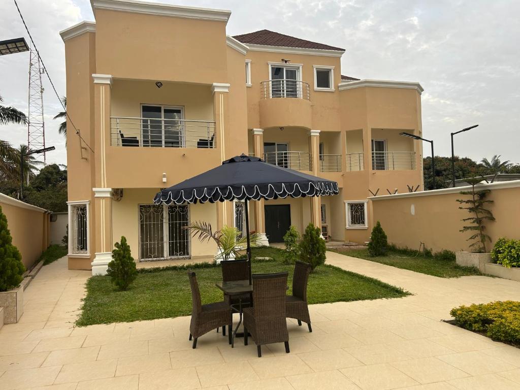 a house with a table and chairs in front of it at Ocean Gem in Bakau