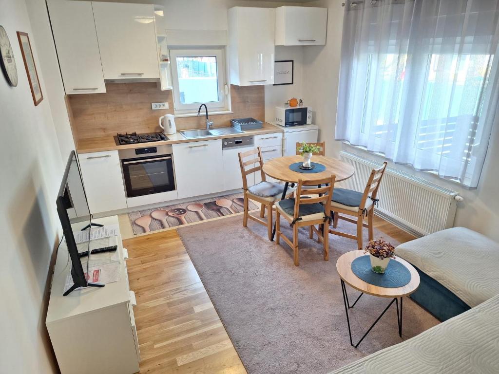 a small kitchen and dining room with a table and chairs at Apartment Silvia Zagreb- Free Private Parking, in Zagreb