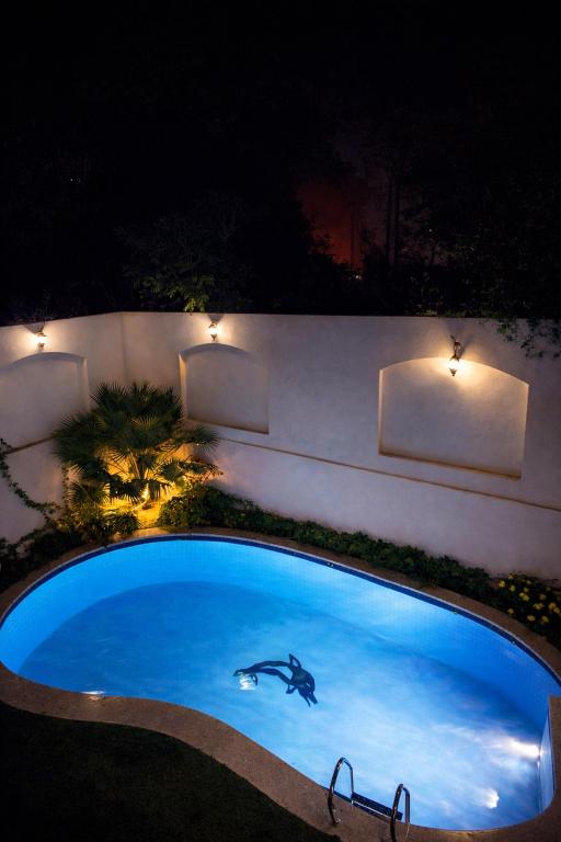 a large blue swimming pool at night with lights at Luxury Villa Z7 - 6th of October in 6th Of October