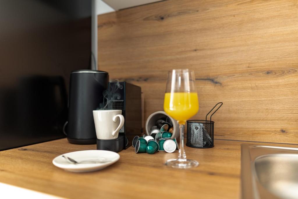 a counter with a glass of orange juice and a plate at Apartmani Opg Dragoslavić in Stari Vas