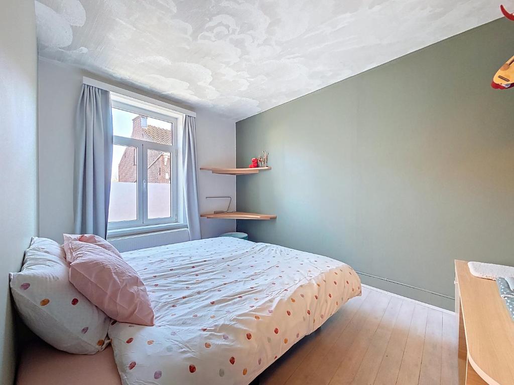 a bedroom with a bed and a window at Bed and Bert in Leuven