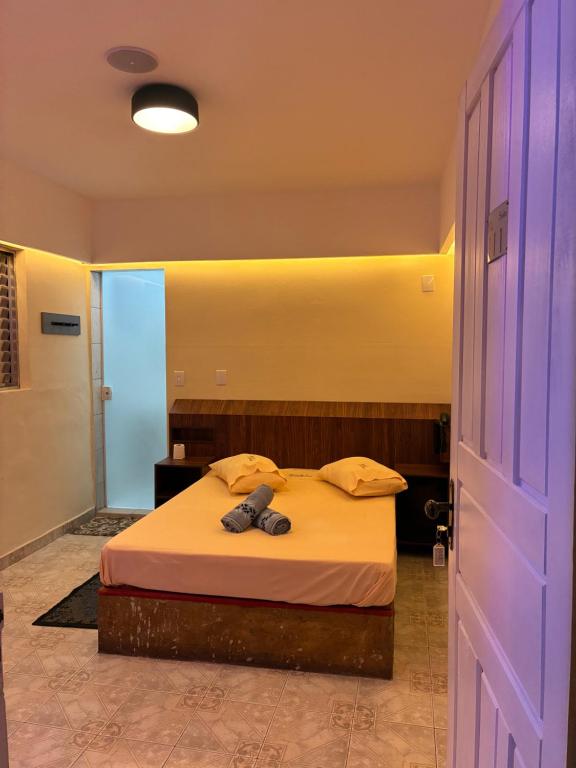 a bedroom with a bed in a room with a door at HOTEL SMART LOVE in Carapicuíba