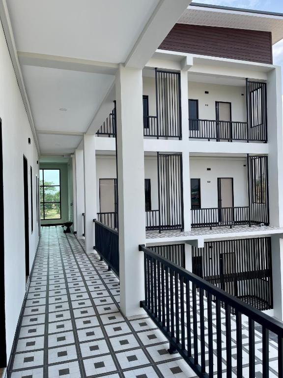 an empty corridor of a building with balconies at AlinApartment in Ban Sa Kruat