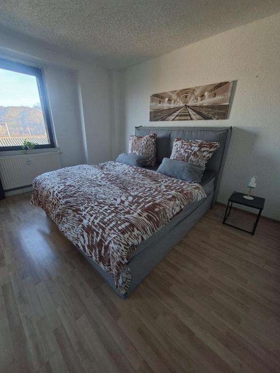 a bedroom with a bed and a large window at Gutliegende Wohnung in Maybach