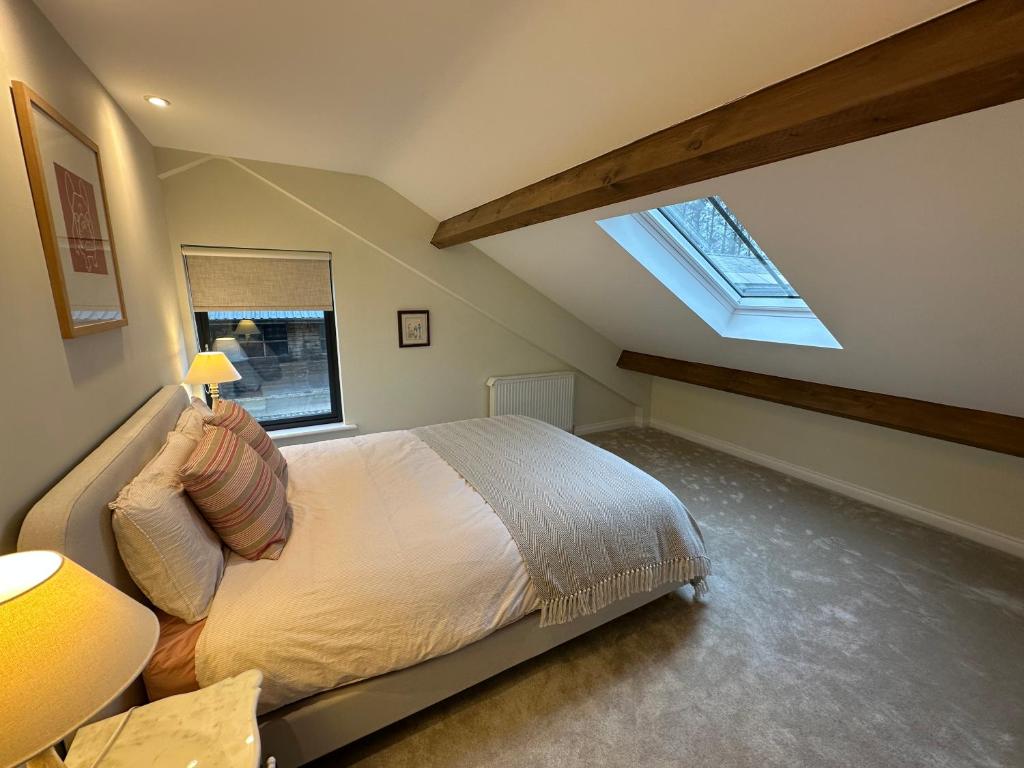 a bedroom with a bed and a skylight at East Barn Bed & Breakfast in Wall
