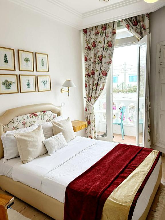 a bedroom with a large bed and a window at Hotel Plaza la marsa in Tunis