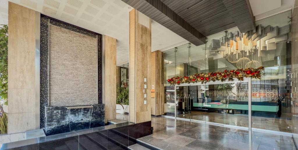 a lobby with a fireplace and a chandelier at Hotel Marbella in Mexico City