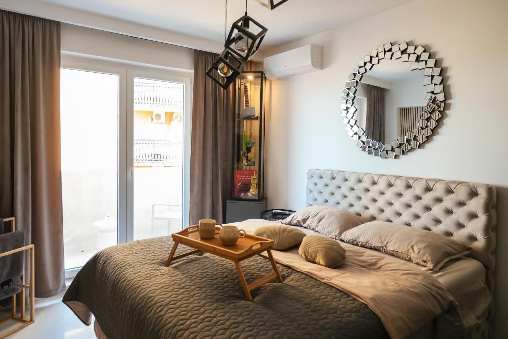 a bedroom with a large bed with a table on it at Djuric Apartmani in Zaječar