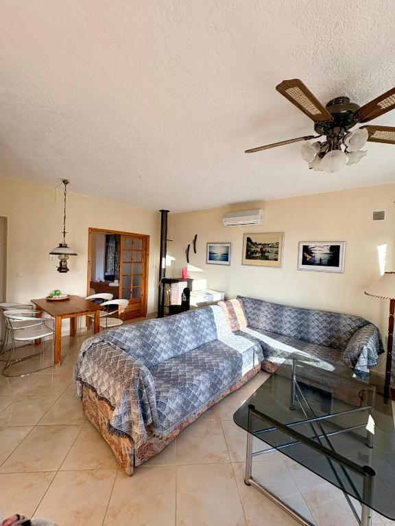 a living room with a couch and a table at AGAPI Holiday House in Vouníon