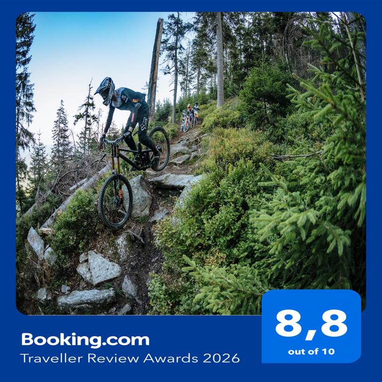 a person riding a bike on a mountain trail at Park Linowy- Bike Park & Spa Czarna Góra Resort in Sienna