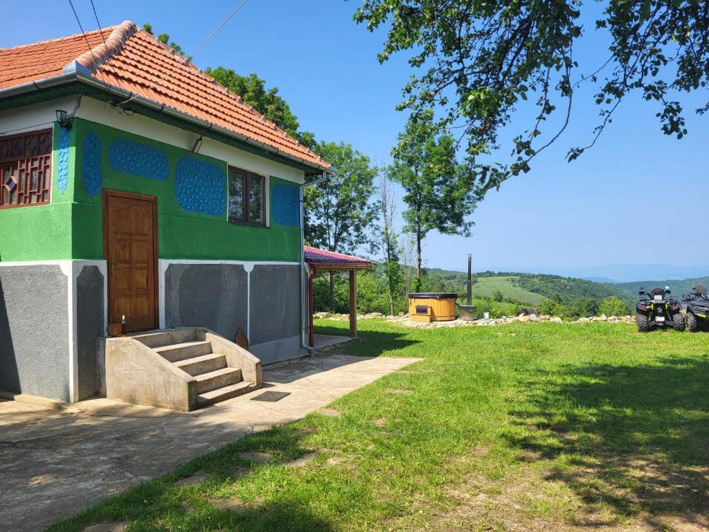a small house with a green and blue paint at Casa Verde in Cerişor