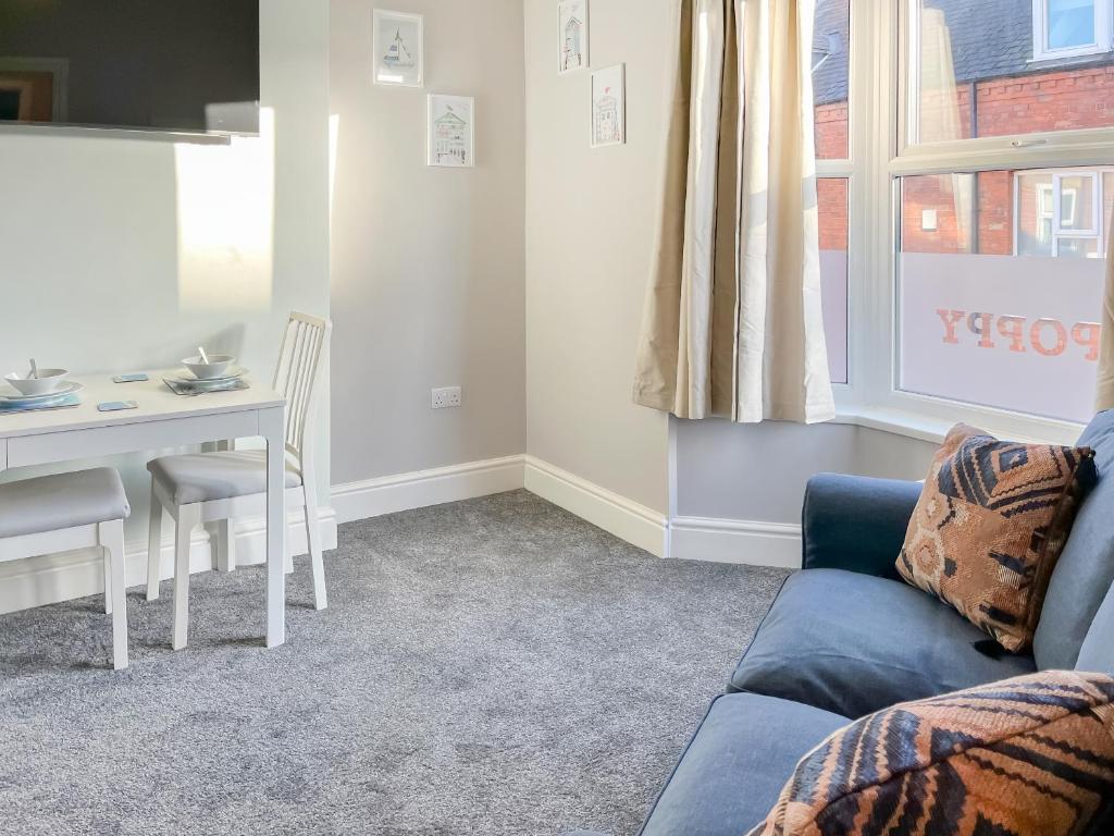 a living room with a couch and a table at Poppy - Uk49361 in Bridlington
