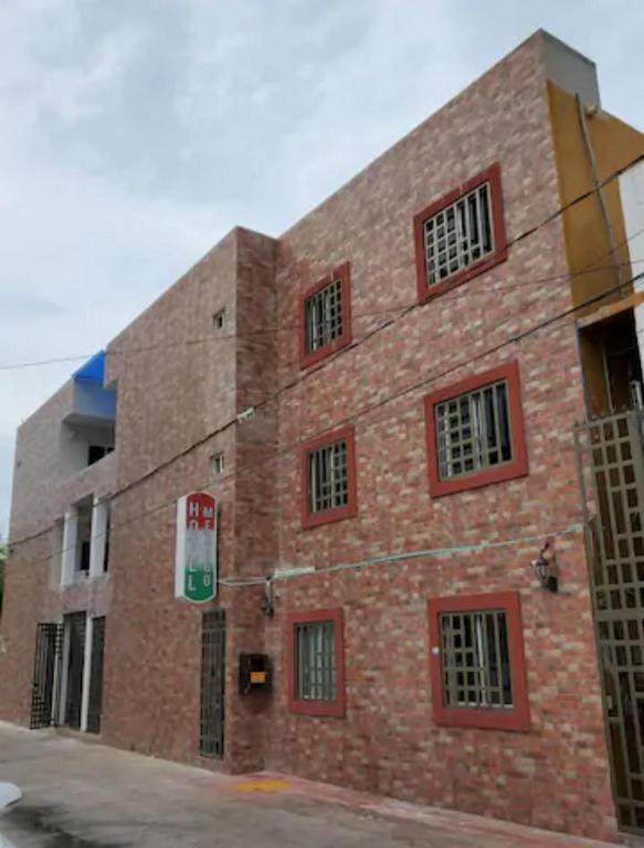 a brick building with red windows on the side of it at Hotel Mexico in Cancún