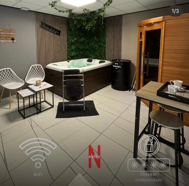 a jacuzzi tub in a room with a table and chairs at Ô Saphir Spa - Maison N3 in Denain