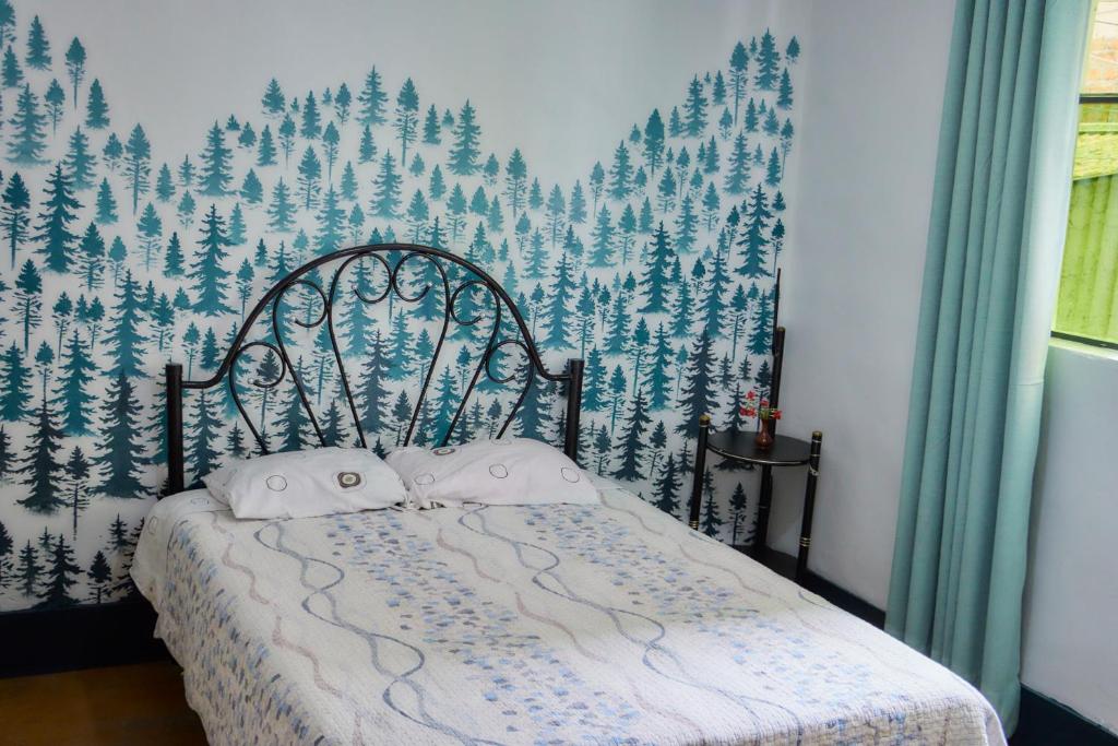 a bed with two pillows on it in a bedroom at TuKasa Boutique Liberdad - Buen cafe en Terraza Interior in Ayacucho