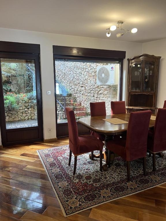 a dining room with a table and chairs at Prestige Old Town Villa in Sarajevo