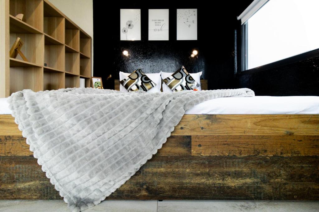 a bedroom with a bed with a blanket on it at The HIDE - Dreamland in Boldeşti-Scăeni