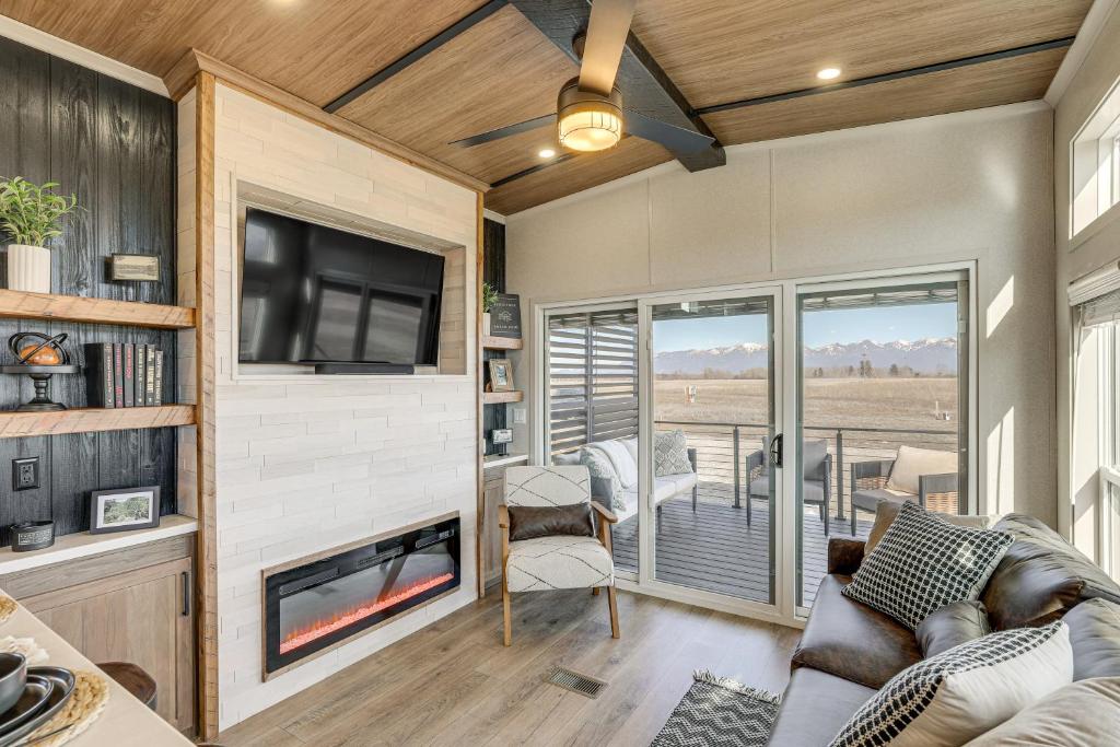 a living room with a fireplace and a tv at "Cozy Montana" Home w/ Mountain Views! in Kalispell