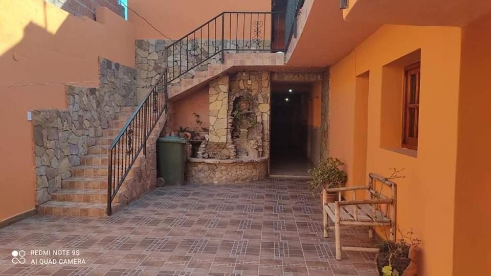 a hallway of a building with a staircase and a building at HOSPEDAJE EIMy in Purmamarca