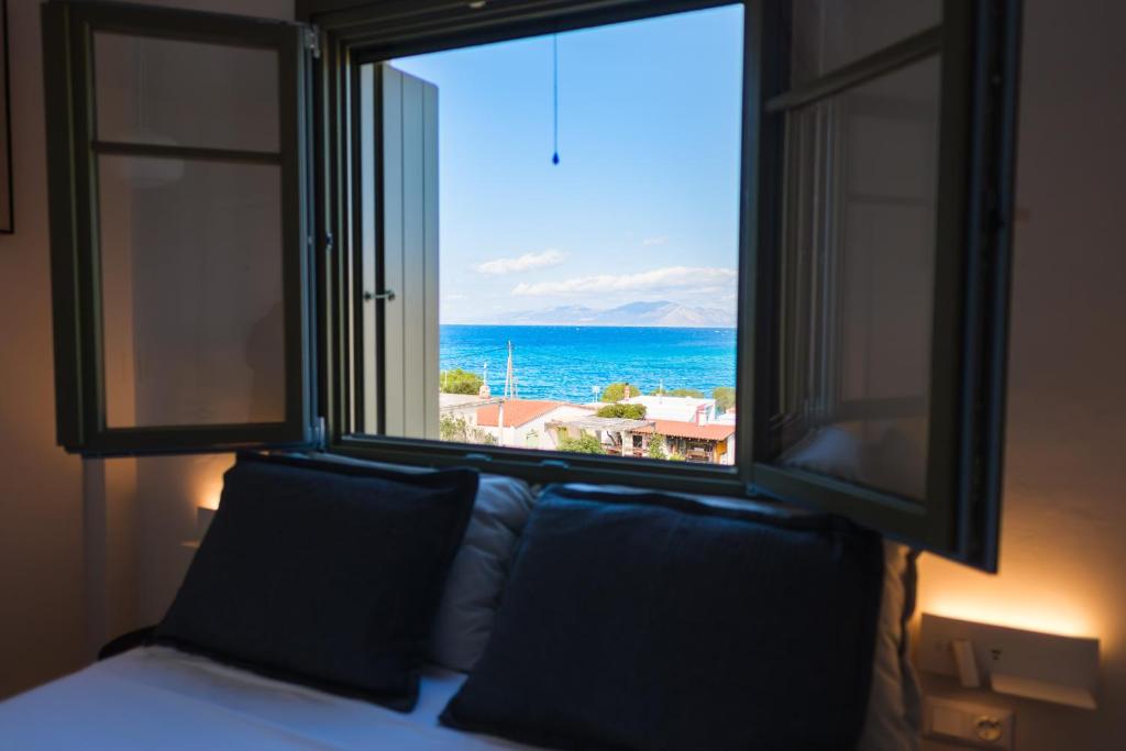 a bedroom with a window with a view of the ocean at Villa Selina 8 - Etheras Properties in Kythira