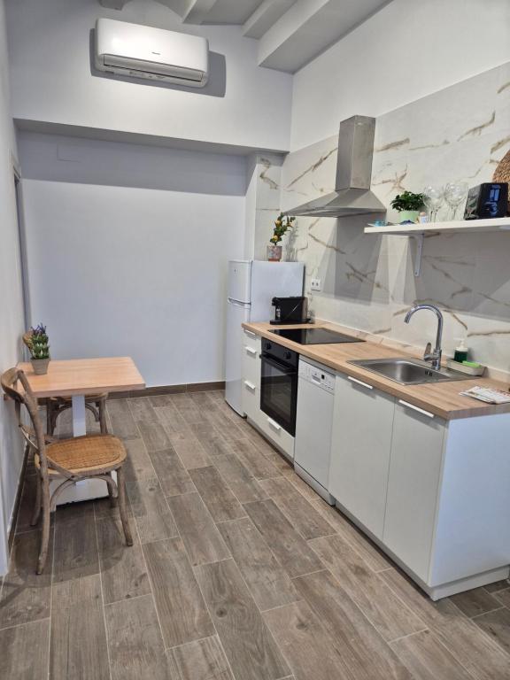 a kitchen with a sink and a wooden table at Pinedo Playa Holiday 2 in Valencia