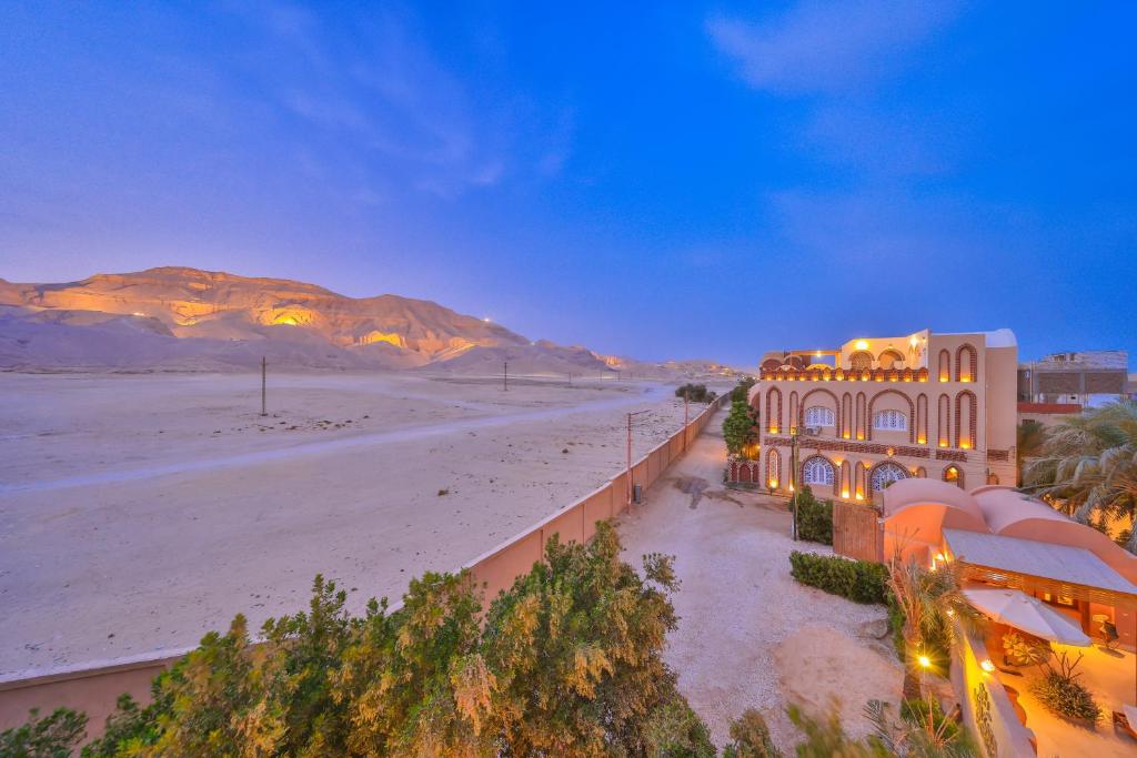 a building on the beach with mountains in the background at Beit El Hanna Valley View in Luxor