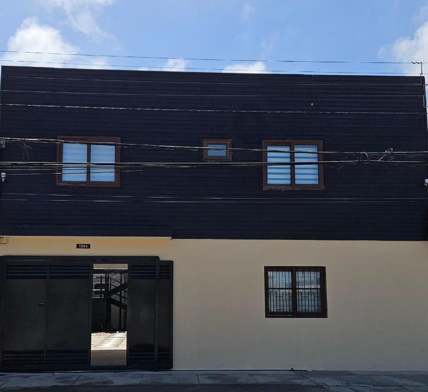 a black and white building with a door at Apartamentos TerraLoft in San Antonio