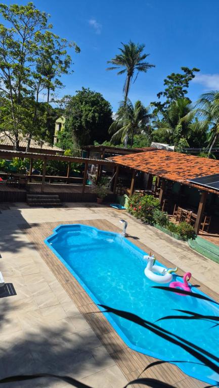 a swimming pool with two inflatable boats in it at Cores de Boipeba in Ilha de Boipeba