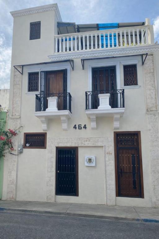 a white building with a lot of windows and doors at CEDOTURT Hotel Boutique & Escuela in Santo Domingo