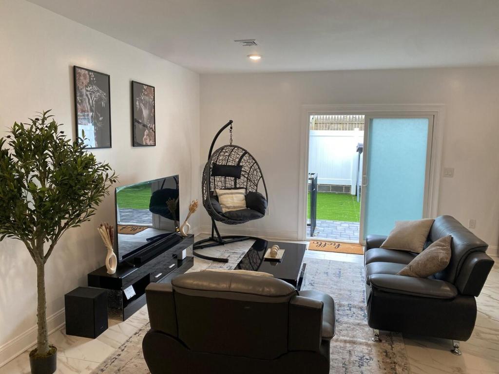 a living room with a couch and a chair at Ekimo Elite Leisure in Jersey City