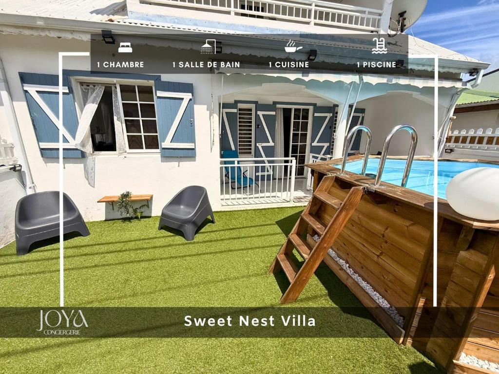 a house with a lawn and a swimming pool at Sweet Nest Villa in Sainte-Rose