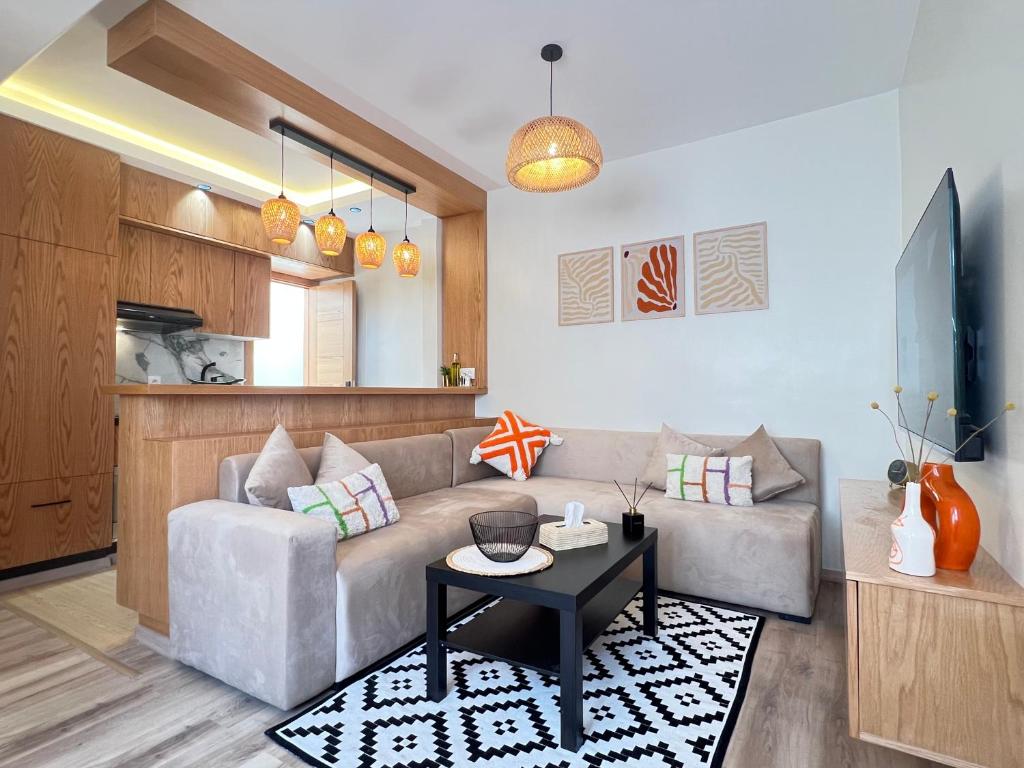 a living room with a couch and a table at Urban Nest Agadir - City Center Apartment in Agadir